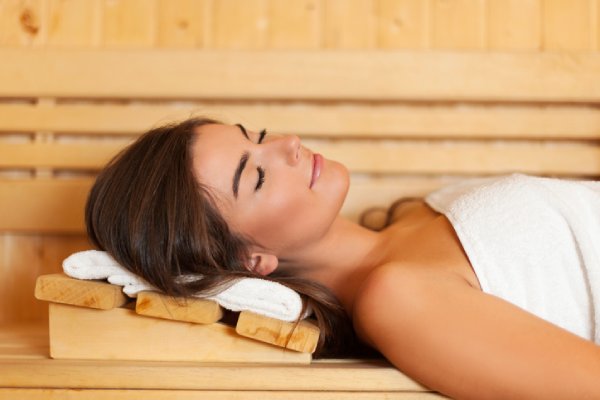 indoor saunas - woman in her sauna resting on a sauna pillow