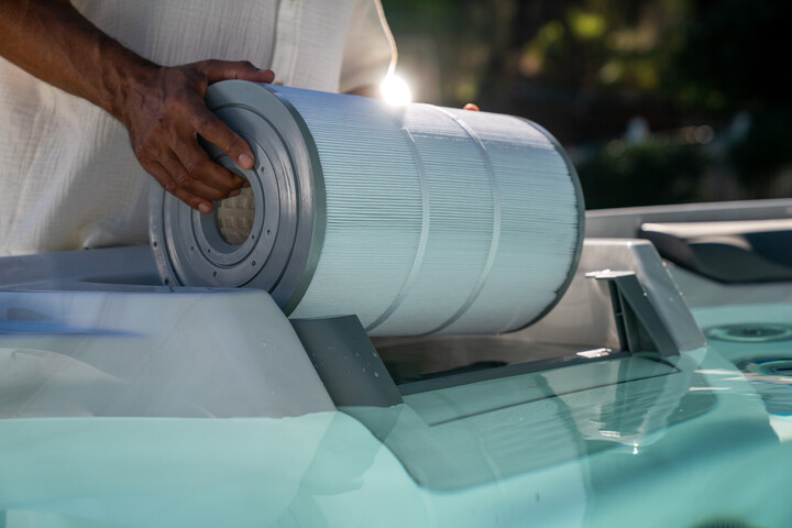 hot tub care - man removing hot tub filter